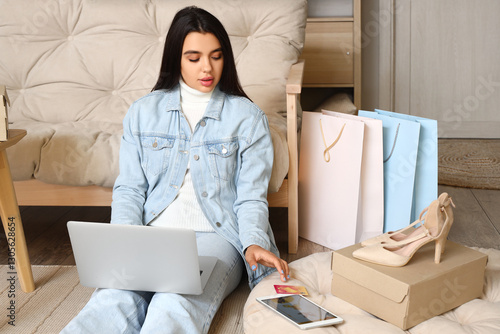 Young woman with laptop sho...