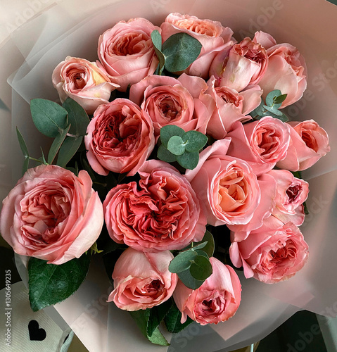 peony pink roses in a bouquet with eucalyptus branches close-up. International Women's Day, gift, care