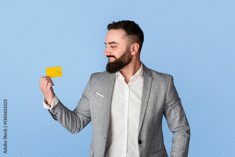 Smiling company employee showing credit card on blue background, empty space Smiling company employee showing credit card on blue background, empty space