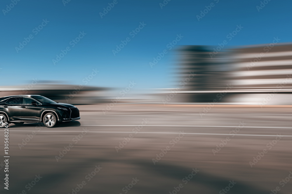 Fast moving car on a blurred background with free space in front of the car. Side view of a moving SUV