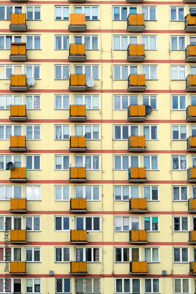 Old obsolete block building with yellow balconies. Soviet architecture in Europe, poor living conditions