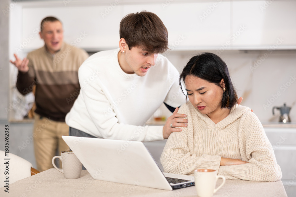 Guy persuades a young girl to stop playing computer games. Upset father in the background Guy persuades a young girl to stop playing computer games. Upset father in the background