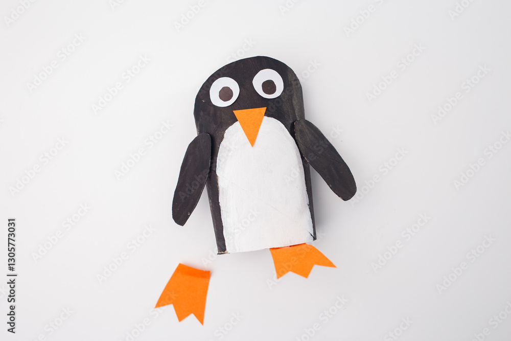 Fototapeta premium A craft representation of a penguin made from paper, showcasing creative progress from above. Ideal for art and craft businesses, educational materials, and DIY project inspiration.