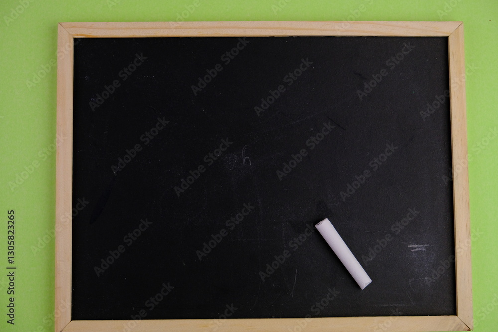 flat lay of a blank black board for text space. Educational and financial concept with text space on white background. surrounded by tools such as pen, alarm clock and calculator flat lay of a blank black board for text space. Educational and financial concept with text space on white background. surrounded by tools such as pen, alarm clock and calculator