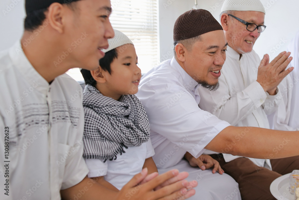 Muslim Family Spending Time Together During Celebration of Eid Al Fitr on The Living Room Muslim Family Spending Time Together During Celebration of Eid Al Fitr on The Living Room