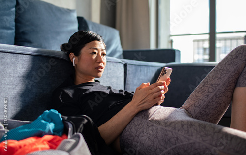 Woman tracking workout progress on fitness app after exercise photo