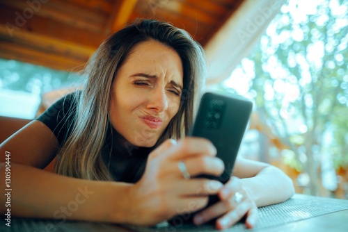 Woman Squinting Trying to See on her Smartphone. Myopic girl having problems reading small texts on a screen 


