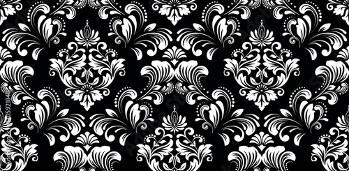 Floral pattern. Seamless vector background. Vintage wallpaper in the Baroque style. White and black ornament for fabric, wallpaper, packaging. Ornate Damask flower illustration.