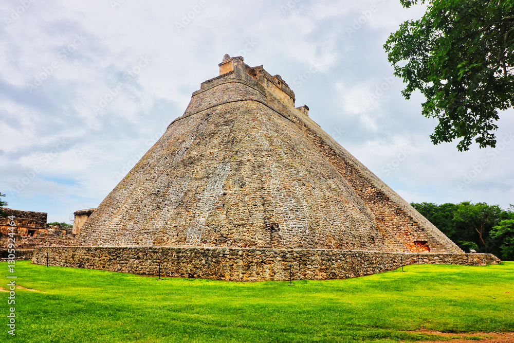 South view of the Unique elliptical sided Great Pyramid of the Magician or Dwarf, built by the Uxmal Mayan rulers between 6th to 10th century CE in Puuc style at Uxmal,Near Merida,Yucatan,Mexico South view of the Unique elliptical sided Great Pyramid of the Magician or Dwarf, built by the Uxmal Mayan rulers between 6th to 10th century CE in Puuc style at Uxmal,Near Merida,Yucatan,Mexico