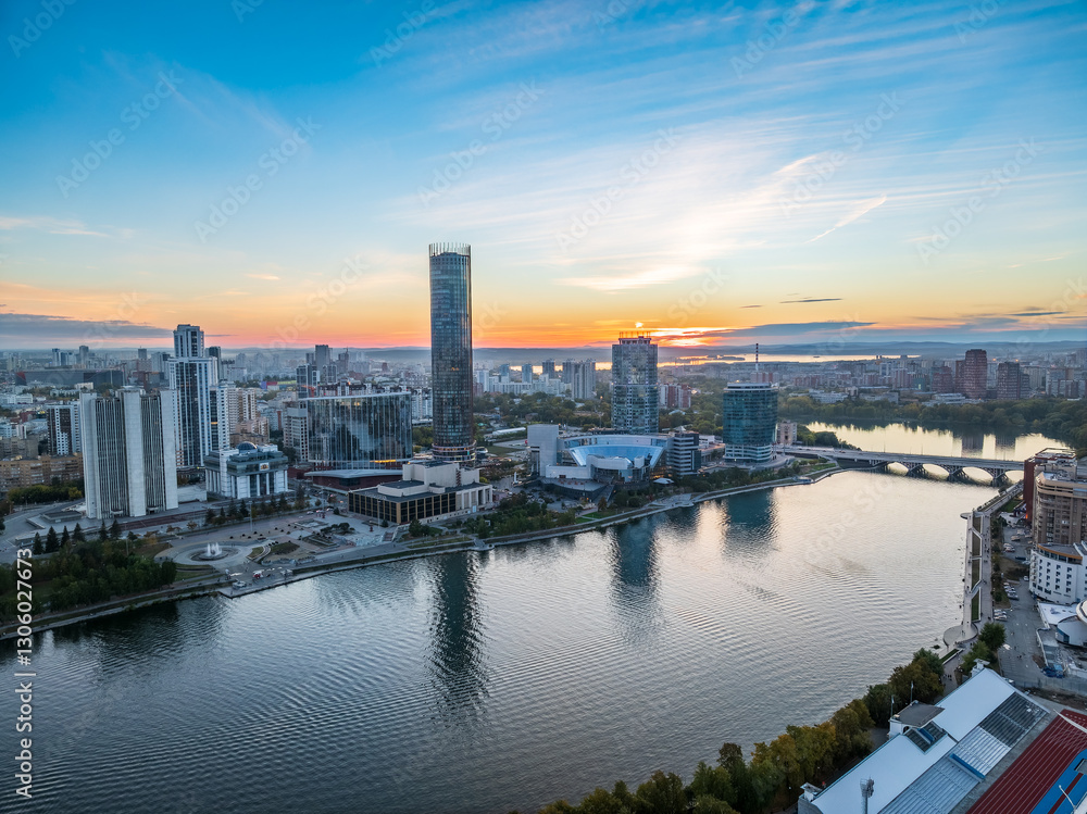 Naklejka premium Yekaterinburg city and pond aerial panoramic view at summer or early autumn sunset. Night city in the early autumn or summer.