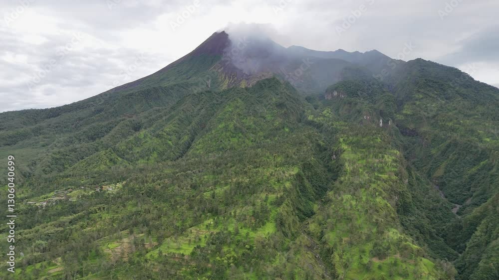 The most active volcano in indonesia, Mount Merapi. Tropical volcano emits smoke from the crater on the top. 4K Aerial drone footage. The most active volcano in indonesia, Mount Merapi. Tropical volcano emits smoke from the crater on the top. 4K Aerial drone footage.