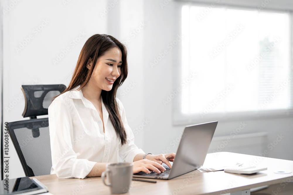Young female entrepreneur working on a laptop at home Young female entrepreneur working on a laptop at home