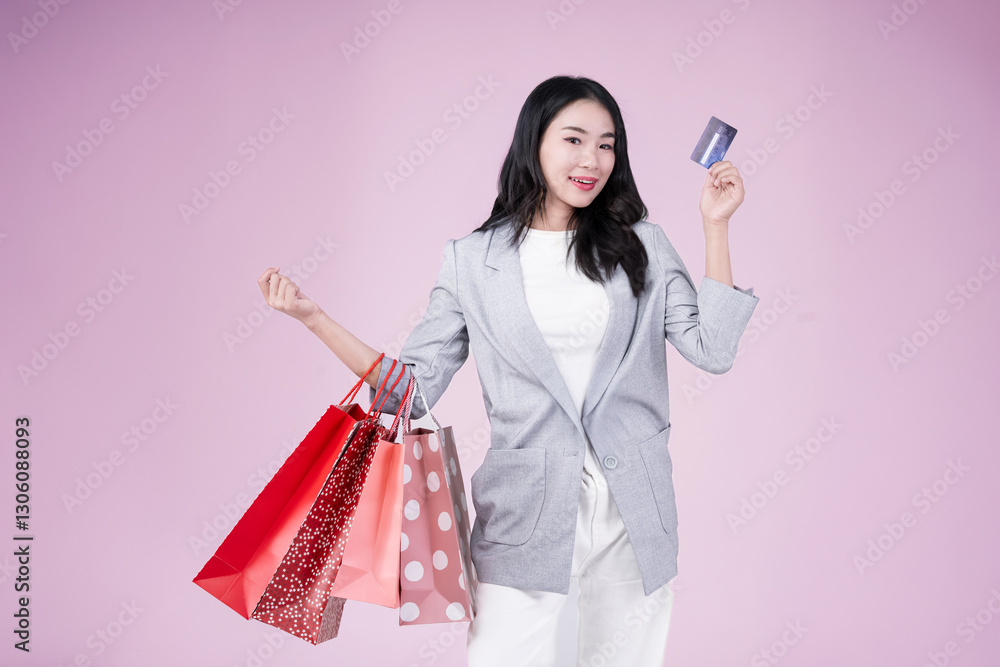 Happy young asian woman hold shopping bags and credit card Happy young asian woman hold shopping bags and credit card