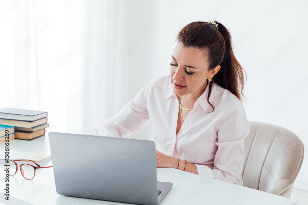 Business woman at desk with laptop learning games online Business woman at desk with laptop learning games online