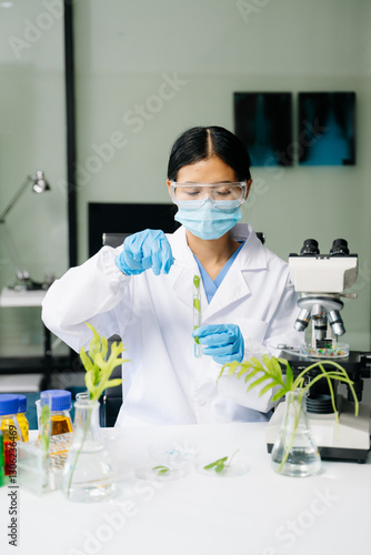 Картината върху платно Biologist taking experiment with plants working in biochemistry laboratory
