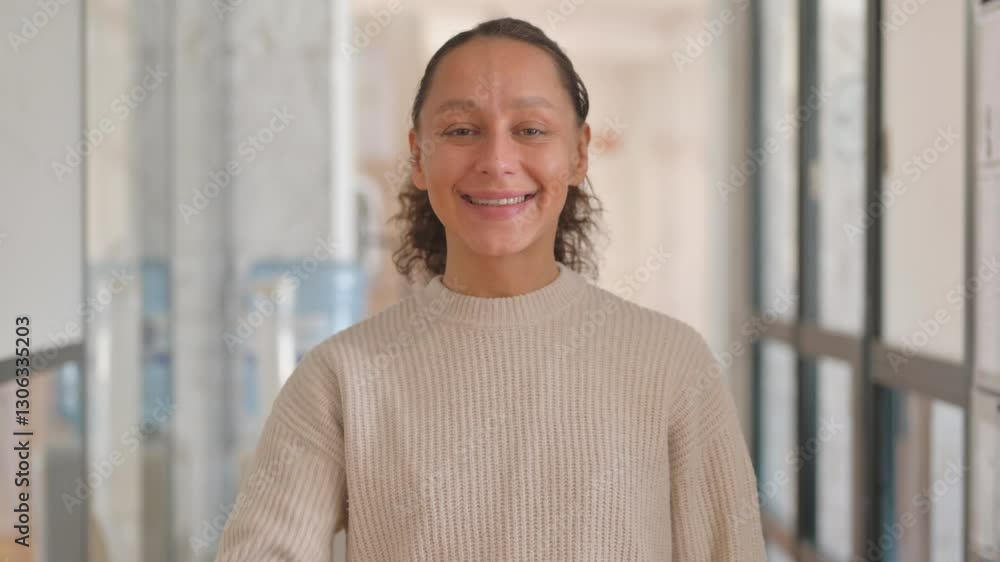 Portrait of Multiracial Woman with Thumbs up Looking at Camera