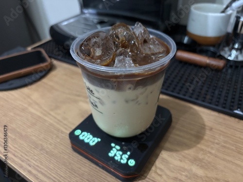Iced Coffee with Milk Palm Sugar in Plastic Cup on Digital Scale