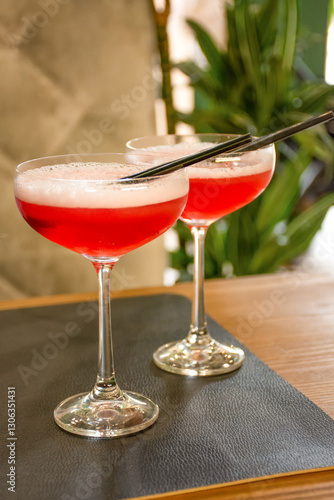 Two cocktail drinks on a wooden table at the bar, summer relaxation. High quality photo
