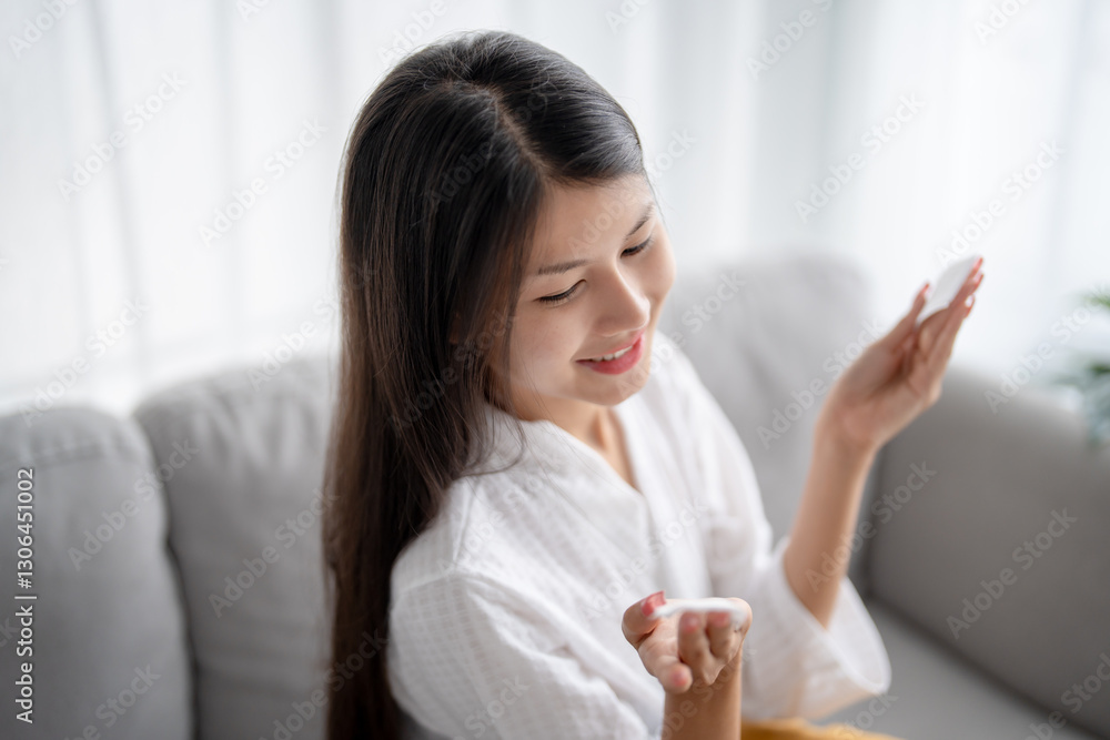 Daily beauty routine Asian woman.with clean skin uses micellar water to remove makeup Daily beauty routine Asian woman.with clean skin uses micellar water to remove makeup