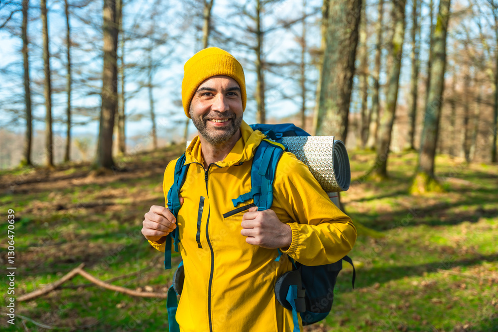 Ταπετσαρία Smiling hiker wearing yellow jacket and backpack hiking in forest