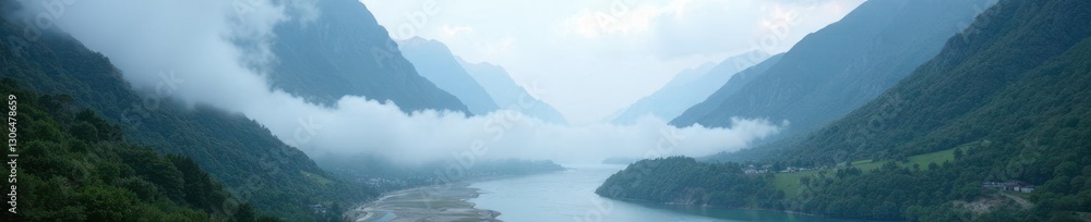 Obraz premium Fog shrouds the valley and river amidst towering mountains, mountains, misty