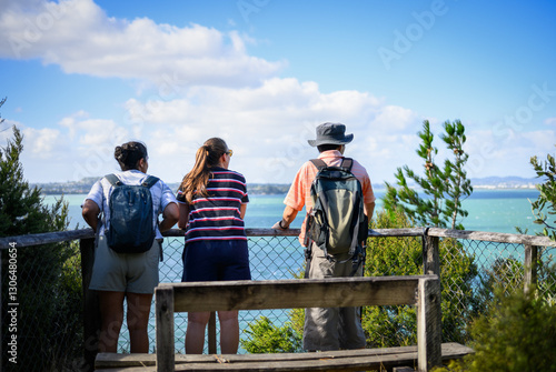 Obraz na płótnie Three people enjoying the view of Waitemata Harbour in summer. Kauri Point Centennial loop track. Auckland. w salonie