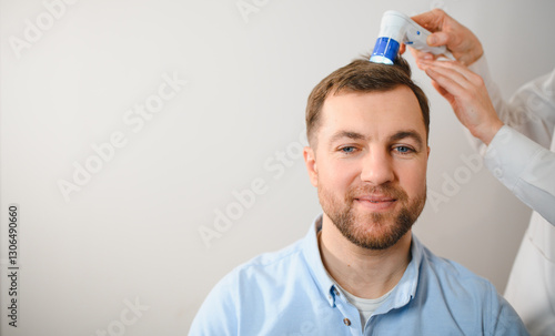 Trichoscope examination of hair, scalp and hair follicles of a young man. Copy space banner photo