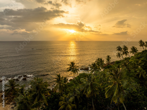 Tropical beach side in South coast of Sri Lank. Amazing sunset on the background over the Indian Ocean