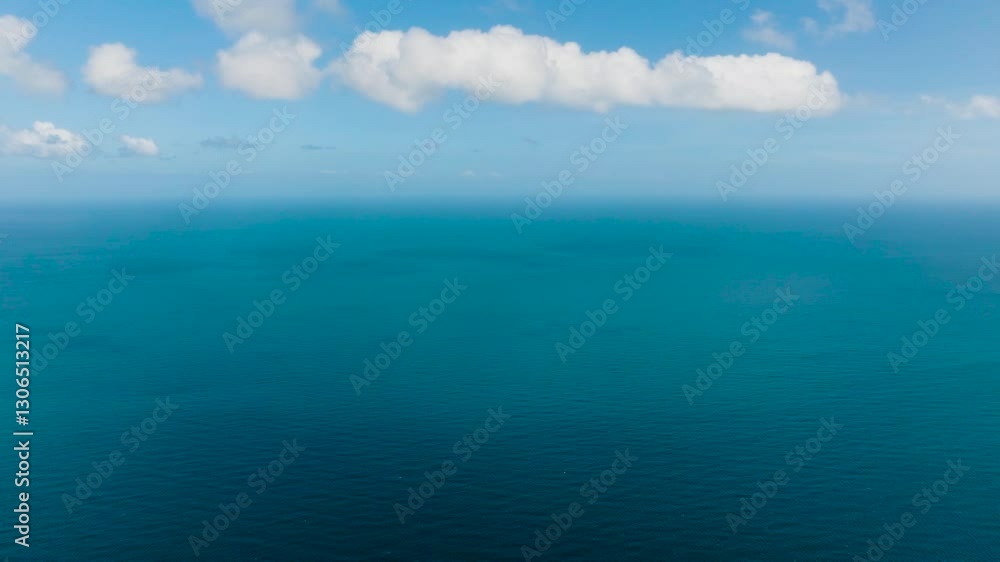 Vast blue ocean extends to the horizon under a clear sky with scattered white clouds. Santa Fe, Tablas, Romblon, Philippines. Vast blue ocean extends to the horizon under a clear sky with scattered white clouds. Santa Fe, Tablas, Romblon, Philippines.
