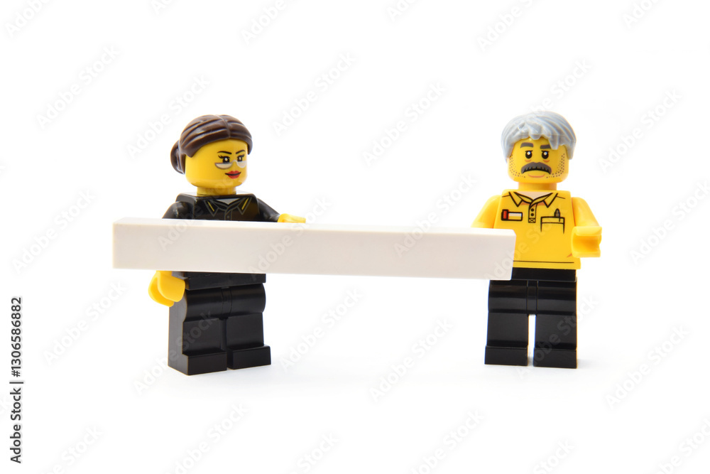 Naklejka premium Lego minifigures of college in uniform. Editorial illustrative image of popular plastic toy constructor.