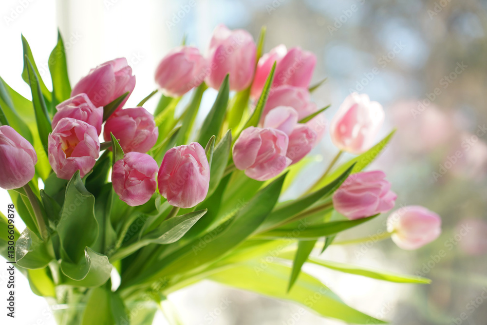 Fototapeta premium Bouquet of pink tulip flowers on spring sky background
