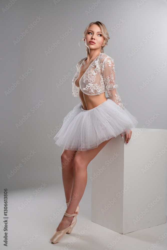 Naklejka premium Elegant woman in lingerie poses gracefully in a dance studio