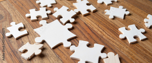 White puzzle piece highlighting absence on wooden tabletop, symbolism of completeness