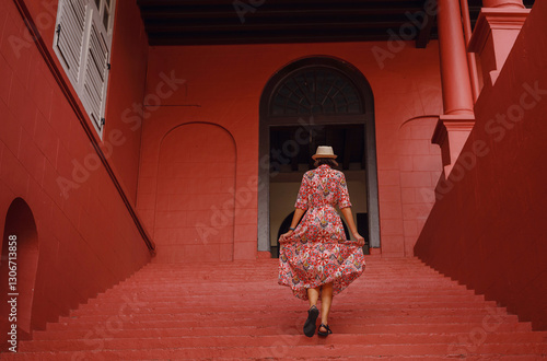 Young woman in ethnic dress and hat exploring the vibrant streets of Malacca, Malaysia. A blend of cultural heritage, colorful architecture, and tropical charm. Perfect travel and lifestyle moments.