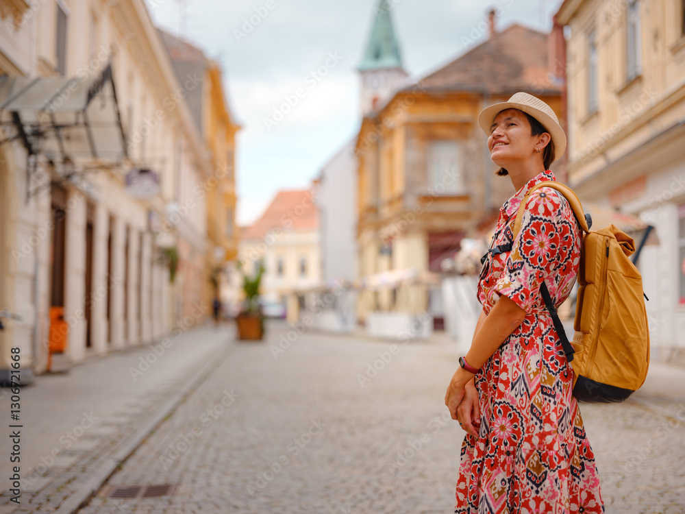 Beautiful woman walking of Varazdin streets during summer day in old, historical city center. Tourist exploring the beautiful streets, experiencing relaxed and cultural vibe of this Croatian city. Beautiful woman walking of Varazdin streets during summer day in old, historical city center. Tourist exploring the beautiful streets, experiencing relaxed and cultural vibe of this Croatian city.