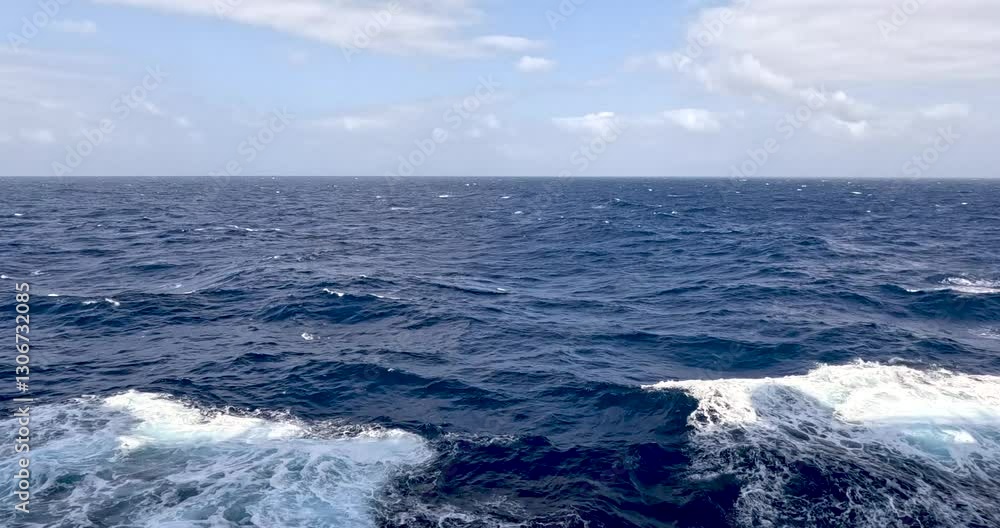 Looking over the ocean, with the ship's shadow in the bow's wake. Looking over the ocean, with the ship's shadow in the bow's wake.