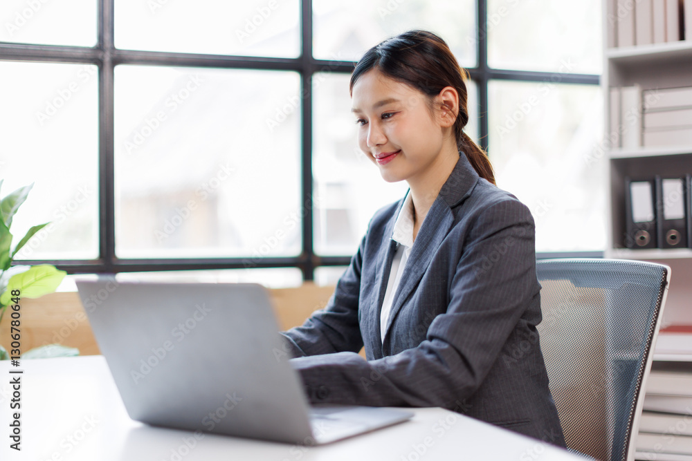 Asian Businesswoman Using laptop computer and working at office calculator document on desk, doing planning analyzing the financial report, business plan investment, finance analysis concept.
Asian Businesswoman Using laptop computer and working at office calculator document on desk, doing planning analyzing the financial report, business plan investment, finance analysis concept.