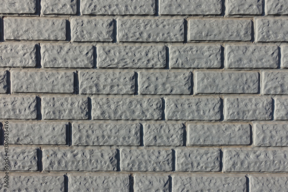 Close shot of Light grey painted brick veneer wall