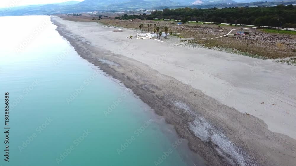 Beautiful panoramic drone shot of the beautiful Ionian coast on an autumn day in Marina di Nova Siri in Basilicata, view of the pine forest promenade and the beautiful sea Beautiful panoramic drone shot of the beautiful Ionian coast on an autumn day in Marina di Nova Siri in Basilicata, view of the pine forest promenade and the beautiful sea