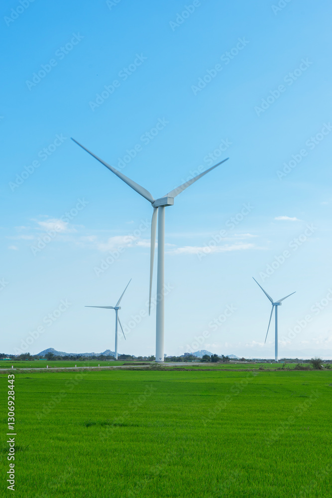 Wind turbines generating electricity on rice field at Phan Rang, Ninh Thuan, Vietnam. Clean energy concept. Windmill for electric power production Wind turbines generating electricity on rice field at Phan Rang, Ninh Thuan, Vietnam. Clean energy concept. Windmill for electric power production