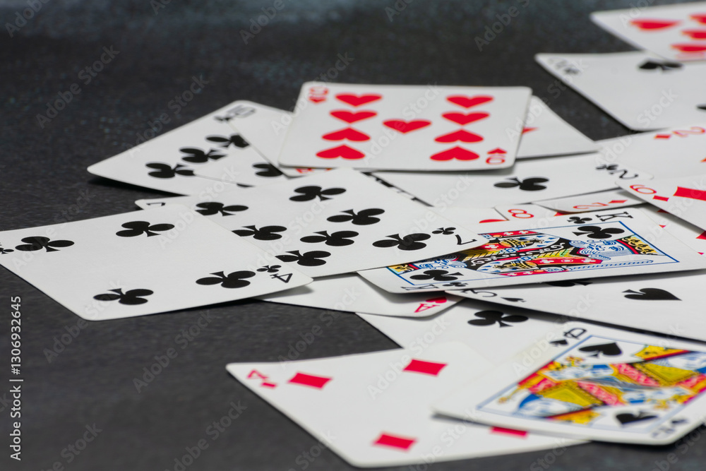 Scattered collection of playing cards, featuring various suits, numbers, and partial card faces. Chaotic arrangement creates a dynamic scene, symbolizing the unpredictability and thrill of card games Scattered collection of playing cards, featuring various suits, numbers, and partial card faces. Chaotic arrangement creates a dynamic scene, symbolizing the unpredictability and thrill of card games