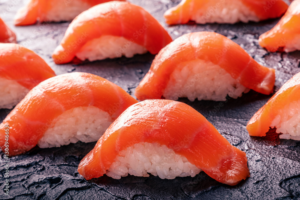 Salmon nigiri sushi on a black slate background, a luxury gourmet set Salmon nigiri sushi on a black slate background, a luxury gourmet set