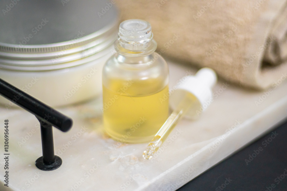 A serum bottle on a marble tray with a soft towel, set against a black background and wooden elements, face care, hydration, nourishment, and spa treatments, promoting skin health and beauty. A serum bottle on a marble tray with a soft towel, set against a black background and wooden elements, face care, hydration, nourishment, and spa treatments, promoting skin health and beauty.
