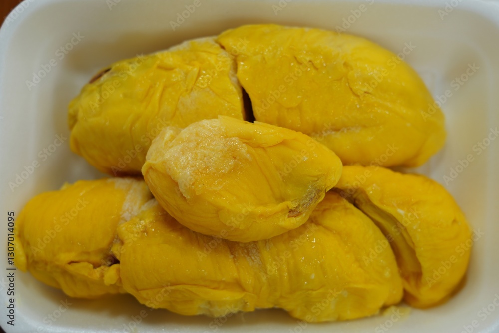 Fresh yllow durian fruit cut open in Singapore