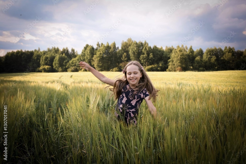 A child runs across the field. Spring/summer photo. Happy childhood, happiness and laughter. Concept of the photo - mother's day, children's day. A child runs across the field. Spring/summer photo. Happy childhood, happiness and laughter. Concept of the photo - mother's day, children's day.