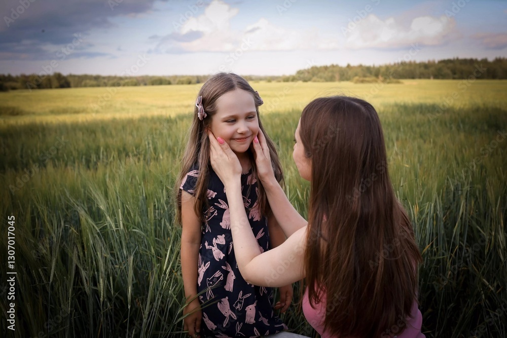 Mom and daughter having fun in a beautiful field. Spring/summer photography. Happy childhood, happiness and laughter. Motherly love and care. The concept of the photo is mother's day, children's day. Mom and daughter having fun in a beautiful field. Spring/summer photography. Happy childhood, happiness and laughter. Motherly love and care. The concept of the photo is mother's day, children's day.