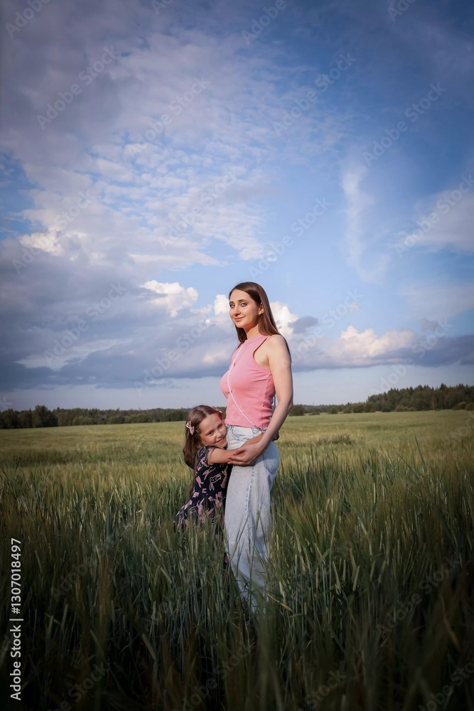 Mom and daughter having fun in a beautiful field. Spring/summer photography. Happy childhood, happiness and laughter. Motherly love and care. The concept of the photo is mother's day, children's day. Mom and daughter having fun in a beautiful field. Spring/summer photography. Happy childhood, happiness and laughter. Motherly love and care. The concept of the photo is mother's day, children's day.