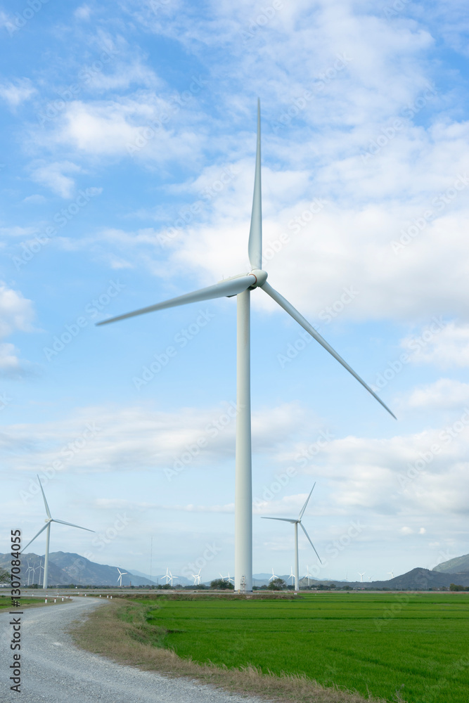 Wind turbines generating electricity on rice field at Phan Rang, Ninh Thuan, Vietnam. Clean energy concept. Windmill for electric power production Wind turbines generating electricity on rice field at Phan Rang, Ninh Thuan, Vietnam. Clean energy concept. Windmill for electric power production
