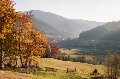 Autumn mountain landscape with beautiful sunrise. Film with grain