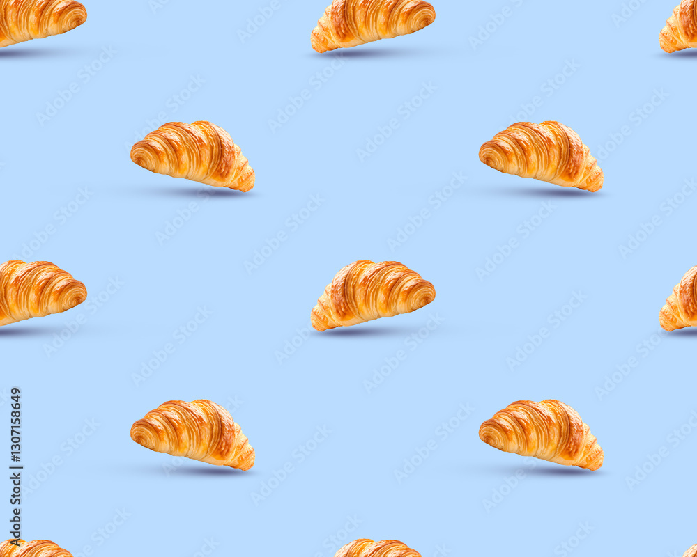 Fototapeta premium Delicious, golden-brown croissants arranged in a seamless pattern, perfect for food-related projects